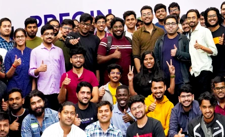 A large group of smiling people posing together for a photo