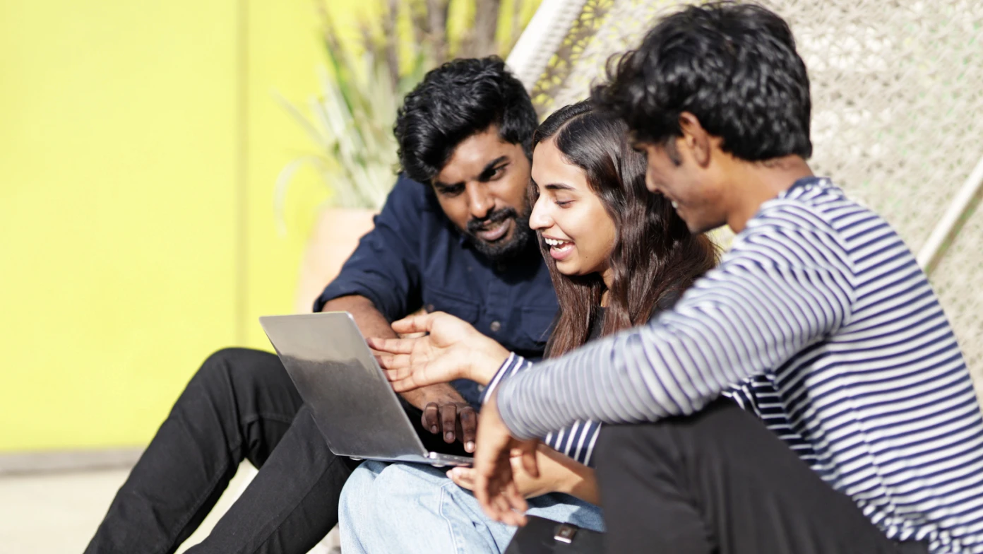 three people smiling laptop