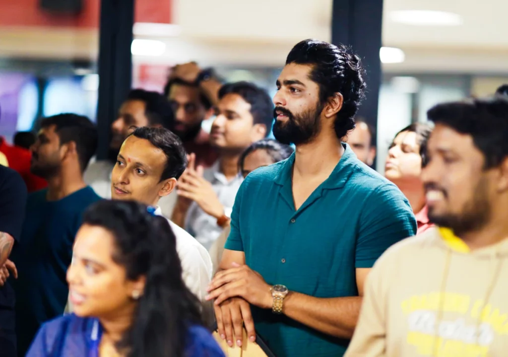 Group of people attentively watching a presentation or event indoors