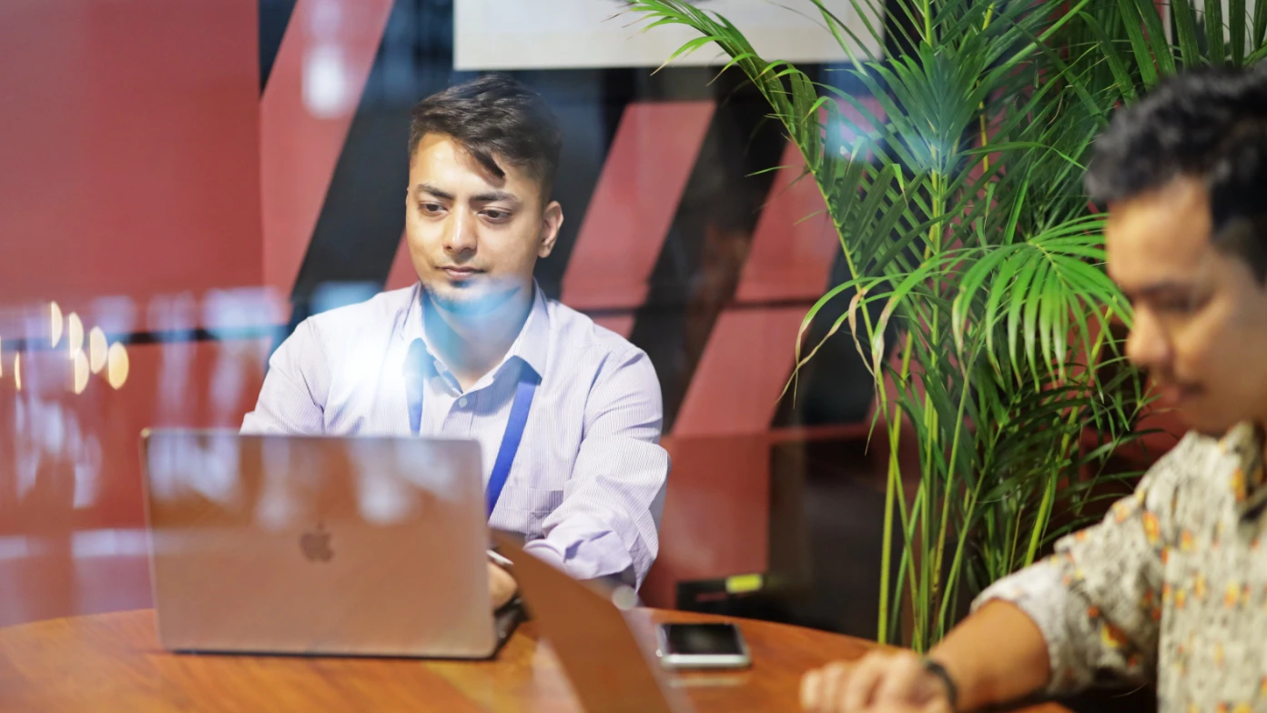 two men with laptop working at the table