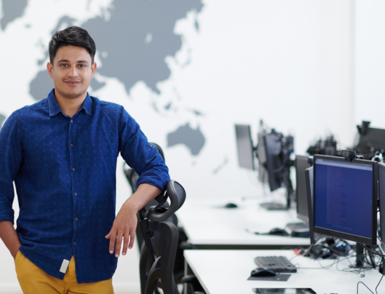 a man poses for a photo in the office