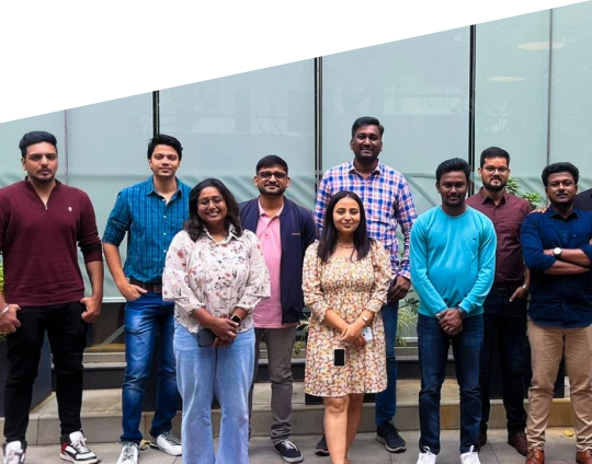 A group of coworkers posing for a photo outside an office building