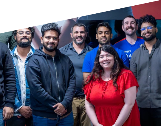 a group of team members standing together and smiling for a photo