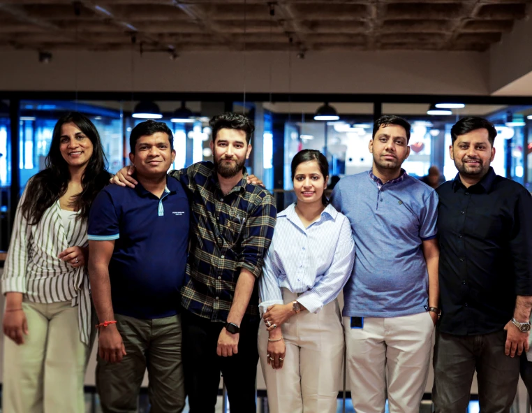 a group of people standing together inside an office