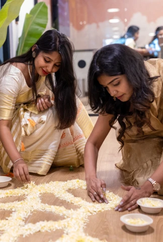 women making a floor decoration indoors