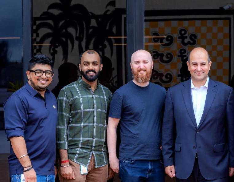 smiling men are standing