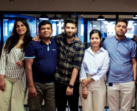 Team members posing together in a modern office