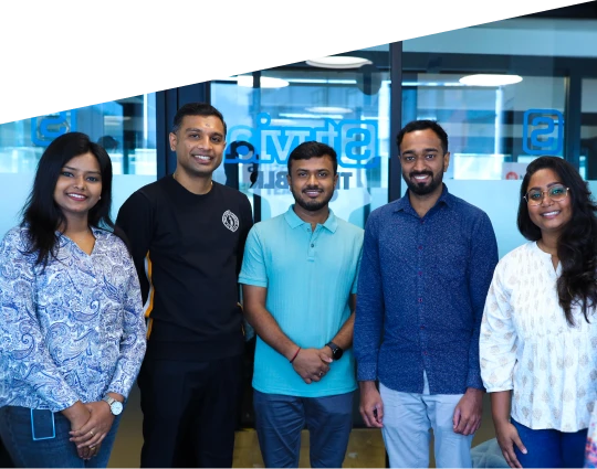 Hero image showing a diverse team of five software developers standing together in a modern office, representing Stuvia’s offshore engineering partnership that increased development speed and capacity.