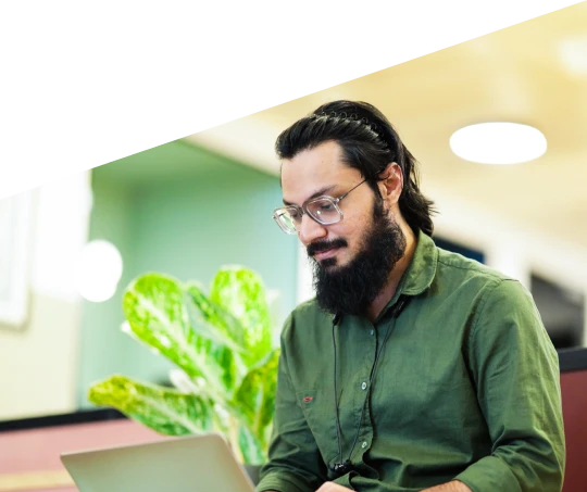 Software engineer in Bangalore, India working on a laptop as part of a dedicated development team