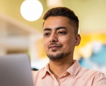 Employee working on a laptop in an office