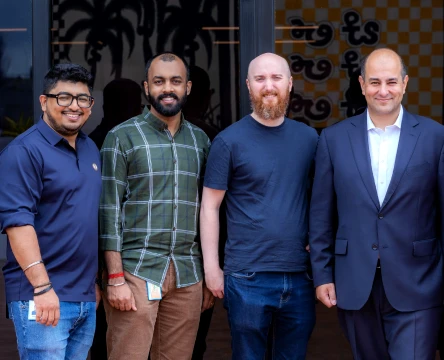 Team members standing together outside a company office