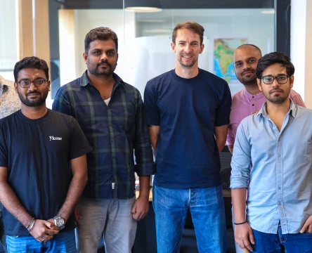 Team members standing together in a modern office