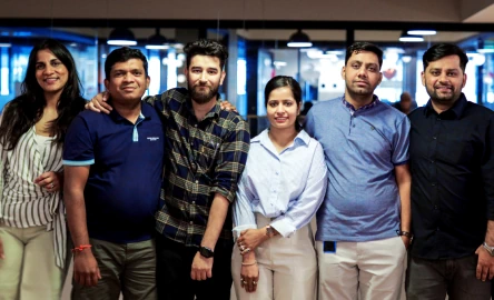 Team members posing together in a modern office