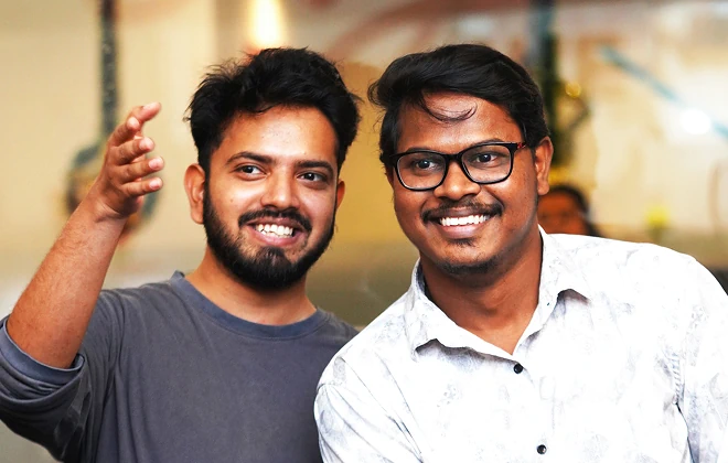 Two men posing and smiling at the camera