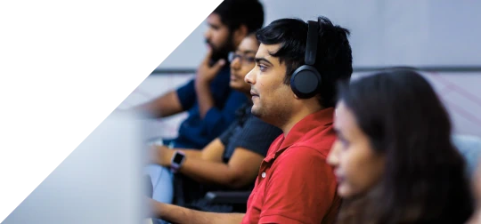 Team members working at computers in an office
