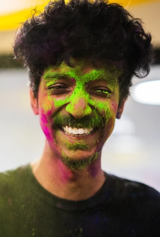 Smiling man with colorful powder on his face