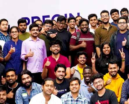 A large group of smiling people posing together for a photo