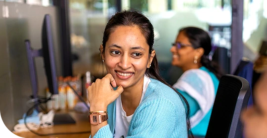 Smiling woman working at a computer in an office