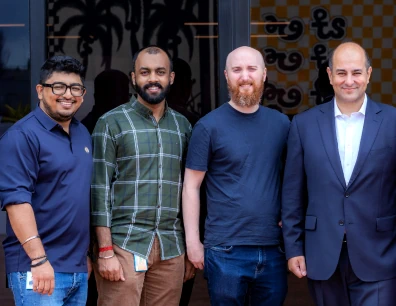 Team members posing together outside a modern office