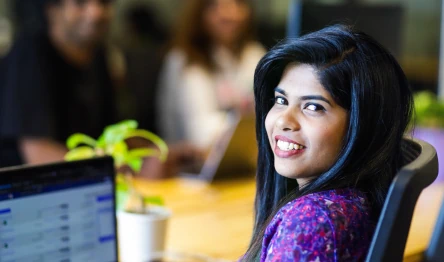 Smiling woman sitting at her desk in an office