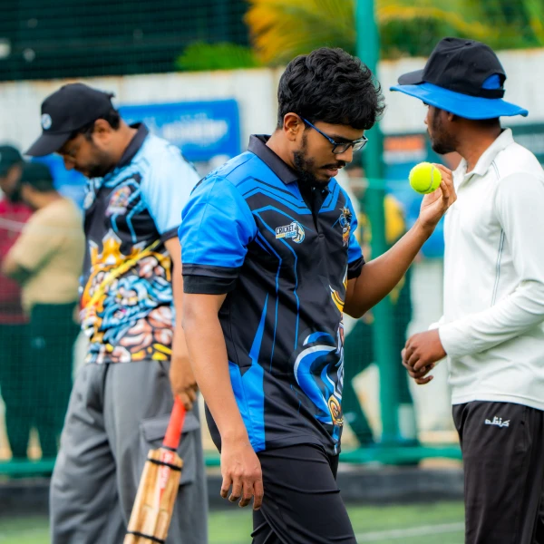 Team members playing cricket together outdoors