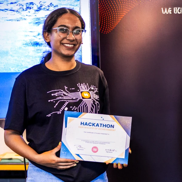 Woman holding a Hackathon certificate of achievement